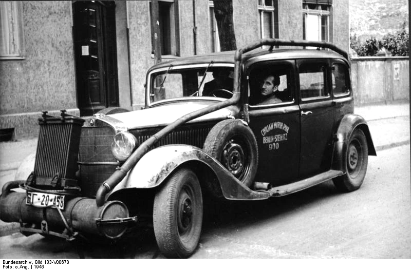 A wood-gas powered car, Berlin, 1946. Note the secondary radiator, required to cool the gas before it’s introduced into the engine. Bundesarchiv, Bild 183-V00670 (CC-BY-SA 3.0).