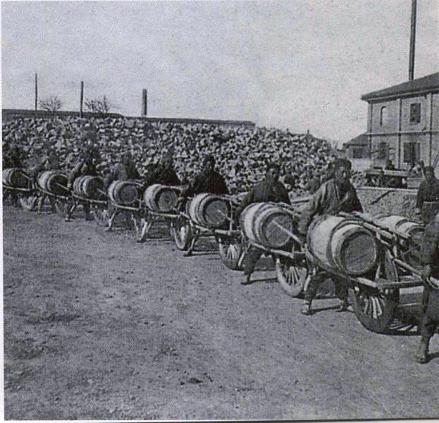 Image: A train of wheelbarrows.