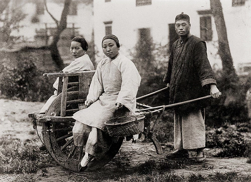 Image: A Chinese wheelbarrow carrying passengers.