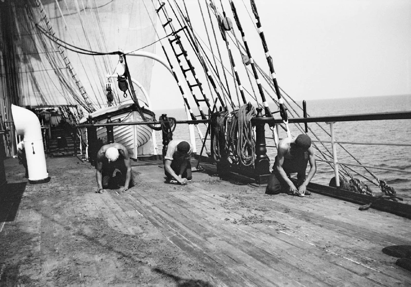 Scraping the deck onboard the &lsquo;Parma&rsquo;. Alan Villiers, 1932-33.