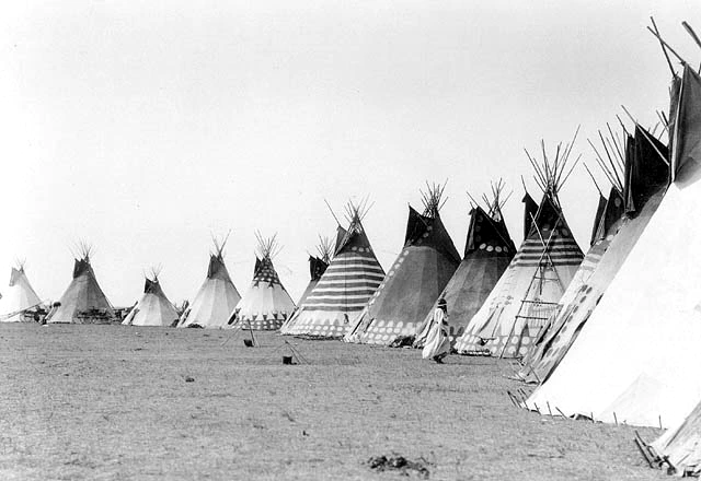 Image: Blackfoot tipis, 1910. Photo credit: Arthur Rafton-Canning. Image in the public domain.