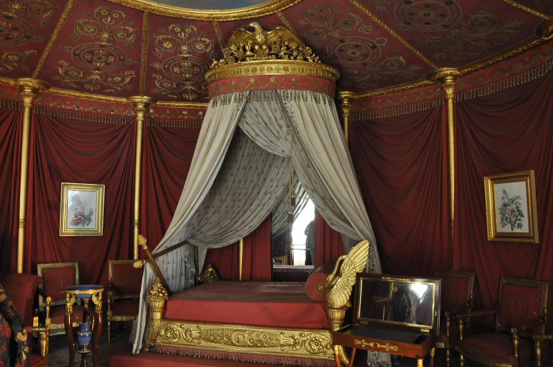 Image: The apartment of empress Joséphine in the Château de Malmaison in Rueil-Malmaison, France. The room of the Empress, luxuriously decorated in 1812 in the shape of a tent with sixteen pieces, exhibits the original bed. Photo credit: Moonik (CC BY-SA 3.0).