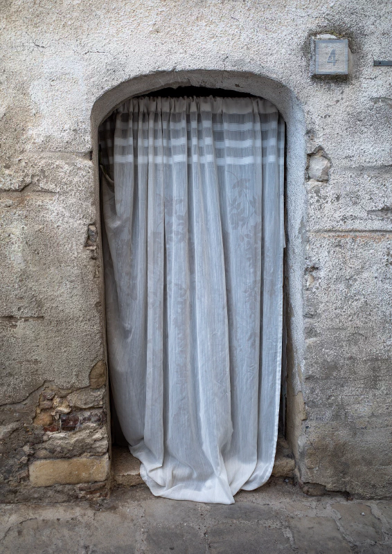 Image: Door curtain covering a house door in Tolve, Italy, 2019. Photo credit: Jules Verne Times Two (CC-BY-SA-4.0).