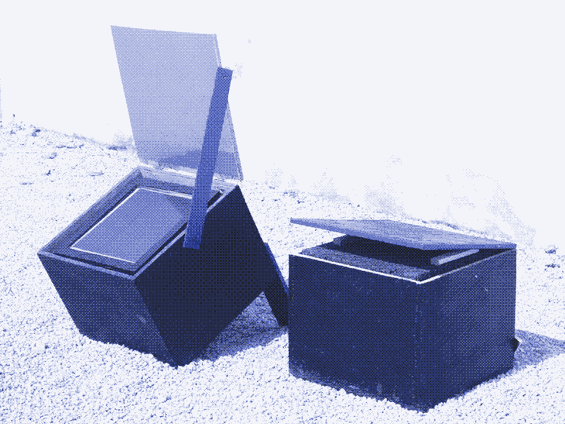 Image: Two conventional, non-electric solar box cookers. Solar energy enters the glass plate and heats up the interior. Built by Audrey Belliot (Slowlab) and Marie Verdeil. Photo by Marie Verdeil.