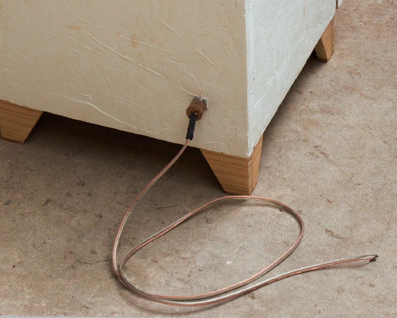 Image: An insulated solar electric cooker is powered by a solar PV panel, which is connected to an electric heating element inside the cooker. Photo by Marie Verdeil.