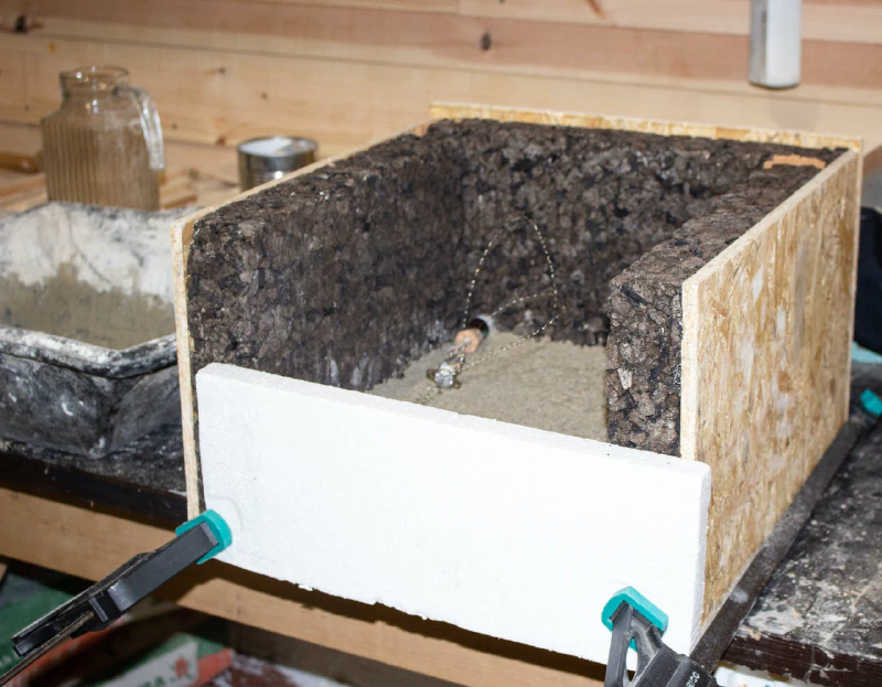 Image: The thermal switch and fuse are seen on the first layer of mortar. Photo by Marie Verdeil.