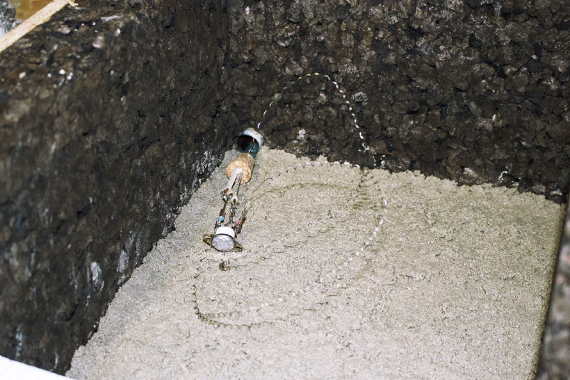 Image: The first layer of mortar with the nichrome circuit, thermal switch, and thermal fuse on top. All these components will be hidden in the second layer of mortar. Photo by Marie Verdeil.