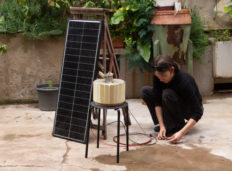 Image: Connecting the coffee maker to a solar panel. Photo by Hugo Lopez.