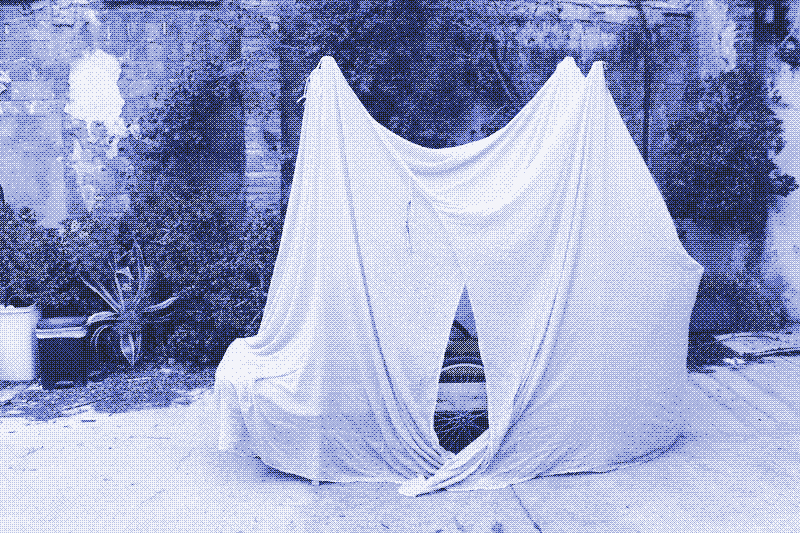 Image: A mosquito net covers the handcart with a sleeping mattress. Photo by Kris De Decker.