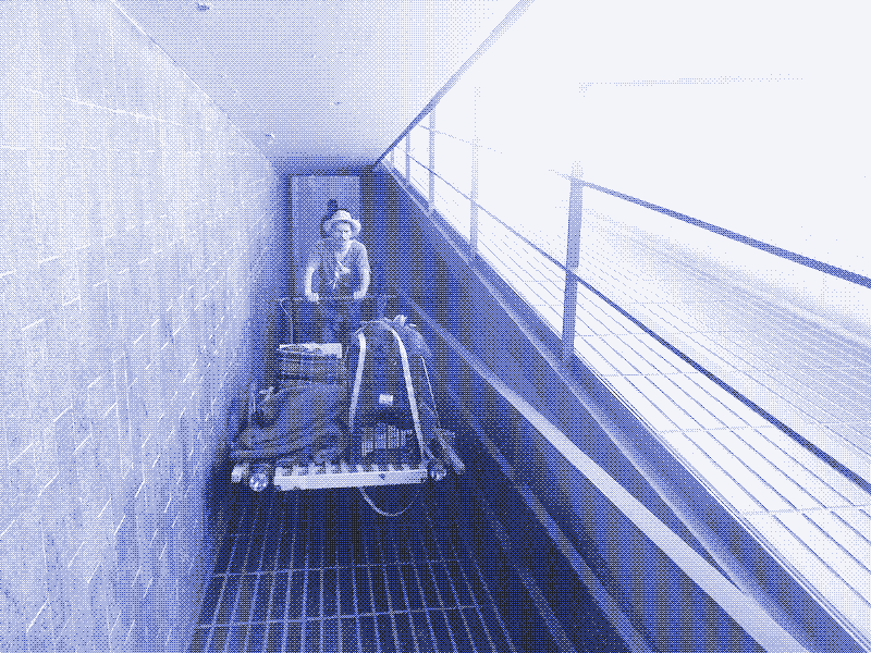 Image: Pushing the handcart through a narrow walkway. Photo by Kris De Decker.