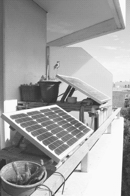 The 50W and 30W solar PV panels on the balcony. One is powering the website, the other is powering the lights in the living room. Image by Marie Verdeil.